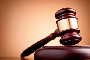 brown gavel on the table on a brown background